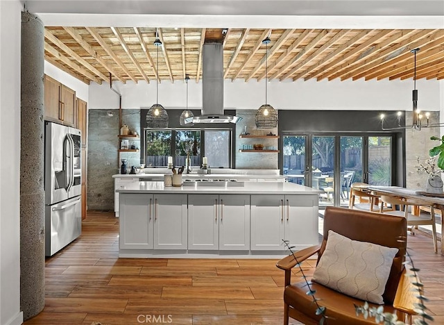31303 Andres Pico Rd, San Juan Capistrano, CA 92675 - kitchen featuring stainless steel refrigerator with ice dispenser, island range hood, light wood-style floors, and light countertops