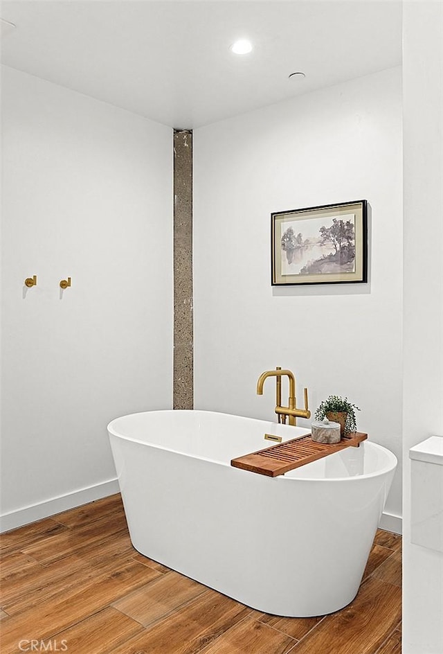31303 Andres Pico Rd, San Juan Capistrano, CA 92675 - bathroom featuring wood finished floors, a soaking tub, baseboards, and recessed lighting