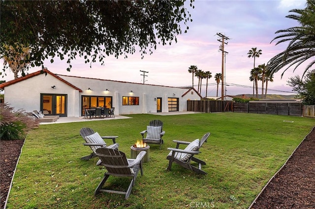 31303 Andres Pico Rd, San Juan Capistrano, CA 92675 - yard at dusk with a fire pit, french doors, and a patio