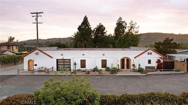 31303 Andres Pico Rd, San Juan Capistrano, CA 92675 - mediterranean / spanish-style house with stucco siding, a mountain view, and french doors