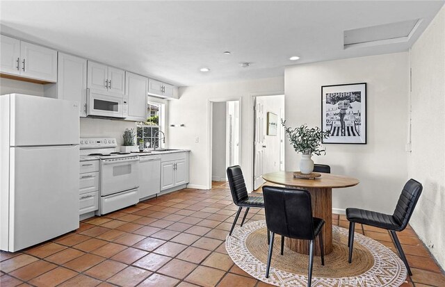31303 Andres Pico Rd, San Juan Capistrano, CA 92675 - kitchen featuring white appliances, white cabinetry, recessed lighting, light tile patterned flooring, and light countertops