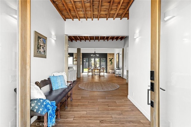 31303 Andres Pico Rd, San Juan Capistrano, CA 92675 - hall featuring wooden ceiling, beam ceiling, wood finished floors, a chandelier, and baseboards