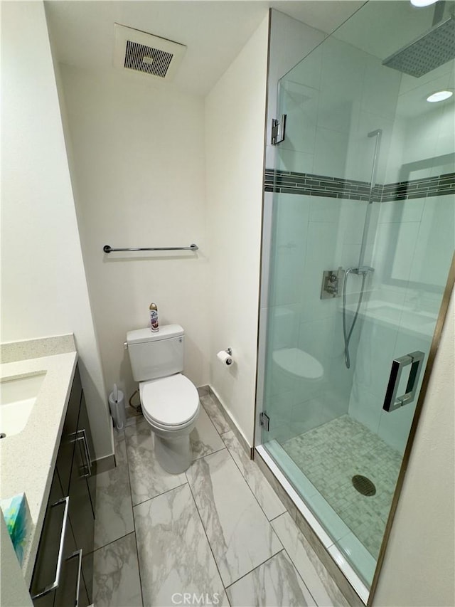 1310 E Ocean Blvd Unit 101, Long Beach, CA 90802 - bathroom featuring marble finish floors, baseboards, toilet, a stall shower, and vanity