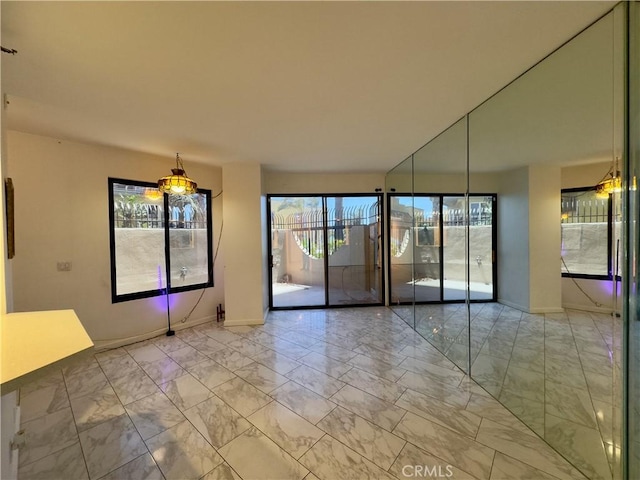 1310 E Ocean Blvd Unit 101, Long Beach, CA 90802 - empty room with light marble finish floors and baseboards