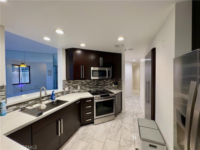 1310 E Ocean Blvd Unit 101, Long Beach, CA 90802 - kitchen with appliances with stainless steel finishes, a sink, light marble finish floors, light countertops, and decorative backsplash