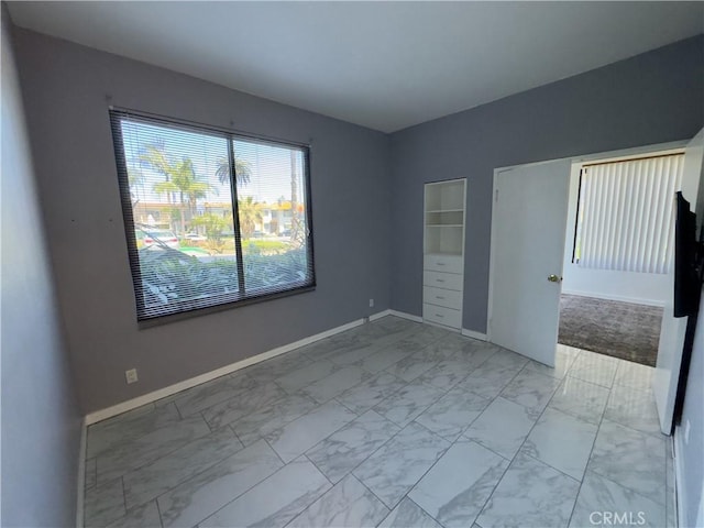 1310 E Ocean Blvd Unit 101, Long Beach, CA 90802 - empty room featuring light marble finish flooring and baseboards