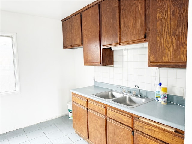 1330 S Reservoir St, Pomona, CA 91766 - kitchen featuring a sink, tasteful backsplash, light countertops, light tile patterned flooring, and baseboards