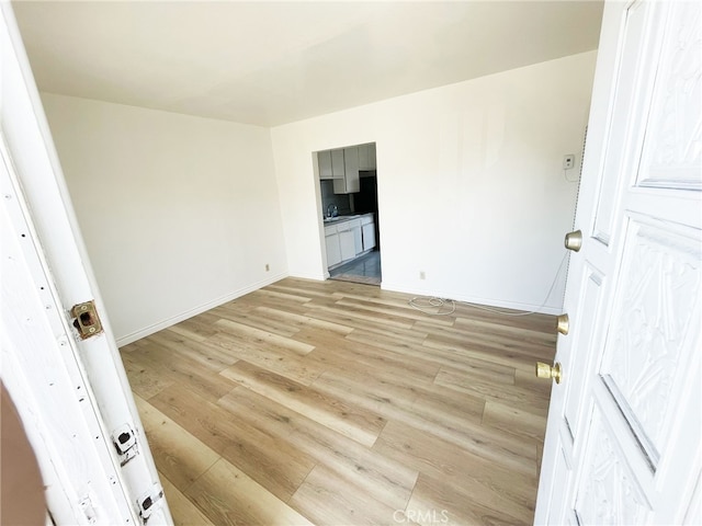 1330 S Reservoir St, Pomona, CA 91766 - unfurnished room featuring light wood-style flooring, baseboards, and a sink