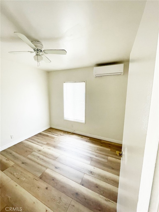1330 S Reservoir St, Pomona, CA 91766 - empty room featuring a wall mounted AC, wood finished floors, ceiling fan, and baseboards