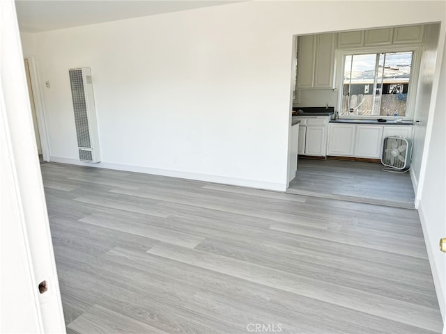 1330 S Reservoir St, Pomona, CA 91766 - empty room featuring a heating unit, baseboards, and light wood-type flooring