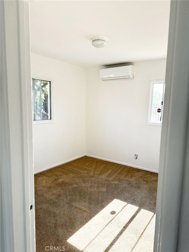 1330 S Reservoir St, Pomona, CA 91766 - carpeted spare room with an AC wall unit and baseboards