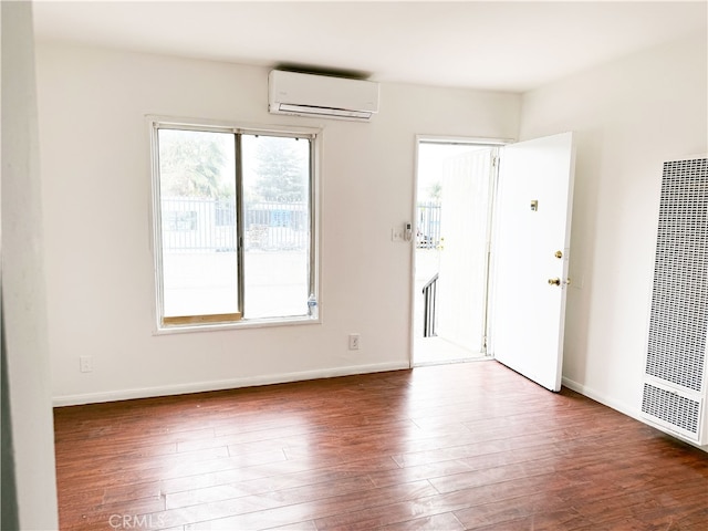 1330 S Reservoir St, Pomona, CA 91766 - spare room with a wall mounted air conditioner, a heating unit, wood finished floors, and baseboards