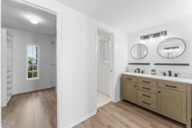 1805 Adelaide Ct, Oxnard, CA 93035 - bathroom featuring wood finished floors, double vanity, and baseboards