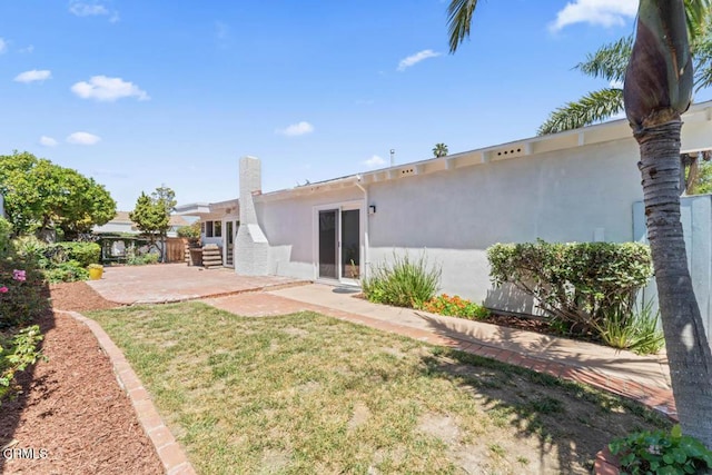 1805 Adelaide Ct, Oxnard, CA 93035 - rear view of house with stucco siding, a patio area, and a lawn