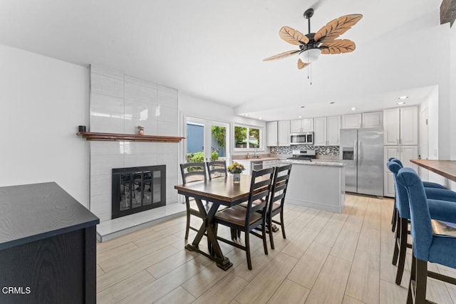 1805 Adelaide Ct, Oxnard, CA 93035 - dining room featuring vaulted ceiling, ceiling fan, a fireplace, light wood-style flooring, and recessed lighting