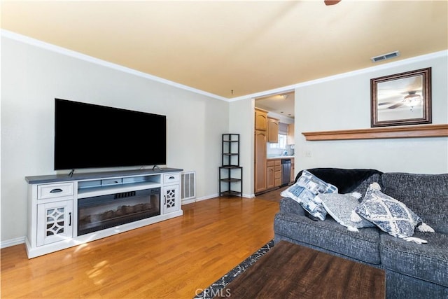 4524 Mananita Ave, Atascadero, CA 93422 - living area featuring light wood finished floors, baseboards, and ornamental molding