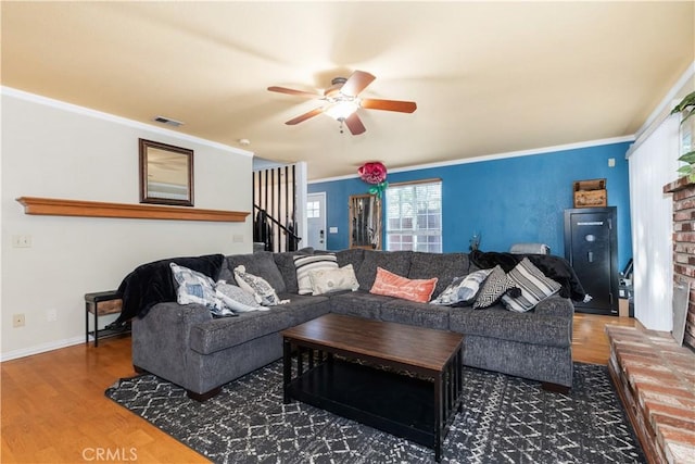 4524 Mananita Ave, Atascadero, CA 93422 - living room featuring wood finished floors, ceiling fan, stairway, a brick fireplace, and ornamental molding