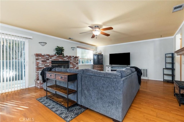 4524 Mananita Ave, Atascadero, CA 93422 - living room with a ceiling fan, crown molding, a fireplace, wood finished floors, and baseboards