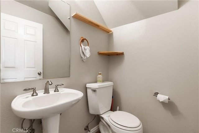 4524 Mananita Ave, Atascadero, CA 93422 - half bathroom featuring toilet, a sink, lofted ceiling, and baseboards