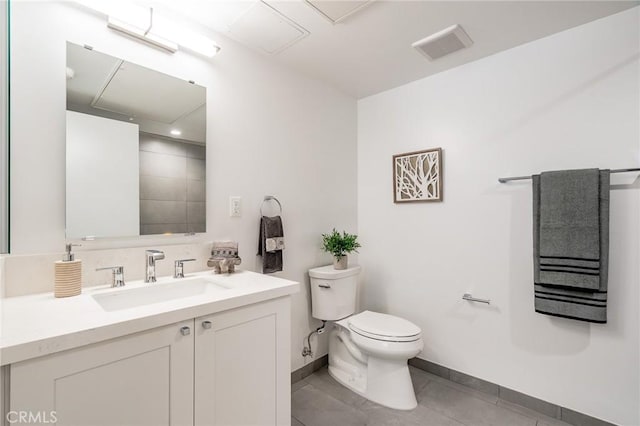 full bath with toilet, baseboards, tile patterned floors, and vanity