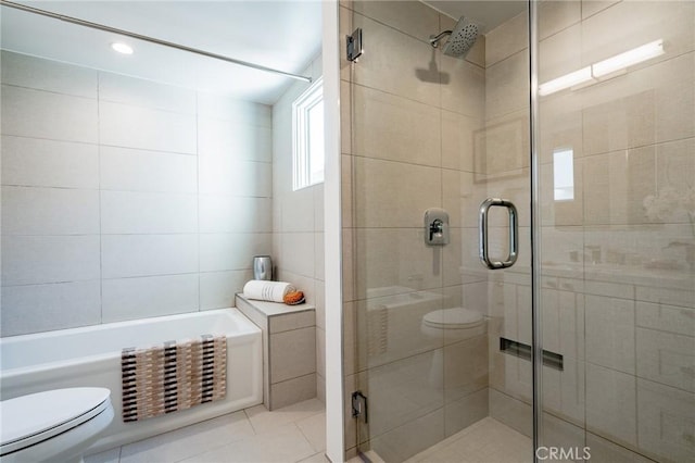 bathroom featuring toilet, a shower stall, tile patterned flooring, a tub, and tile walls