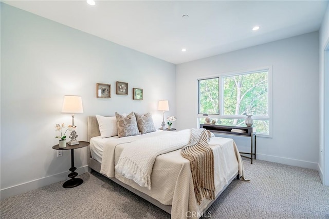carpeted bedroom featuring baseboards and recessed lighting