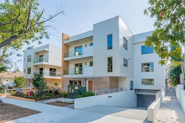 view of apartment building / complex featuring fence