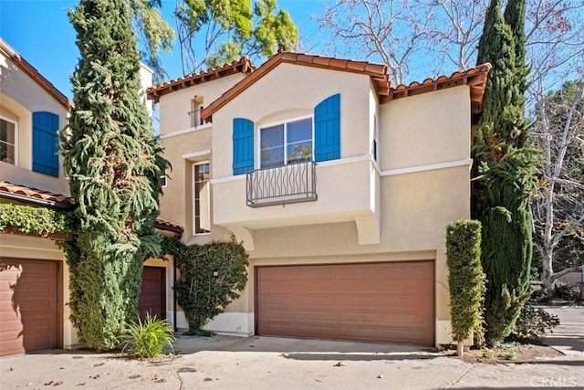 1 Firenze Ct, Newport Coast, CA 92657 - mediterranean / spanish house with a tile roof, a balcony, stucco siding, and an attached garage