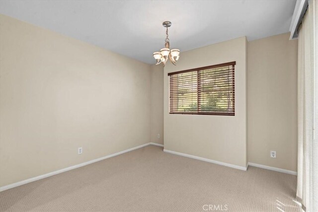 1 Firenze Ct, Newport Coast, CA 92657 - spare room with light colored carpet, a chandelier, and baseboards