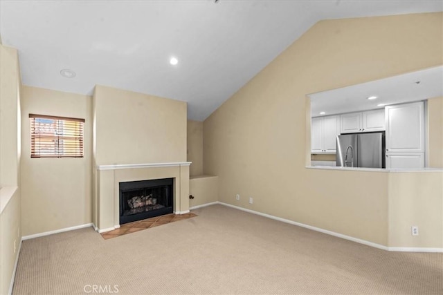 1 Firenze Ct, Newport Coast, CA 92657 - unfurnished living room featuring carpet flooring, vaulted ceiling, a fireplace with flush hearth, baseboards, and recessed lighting