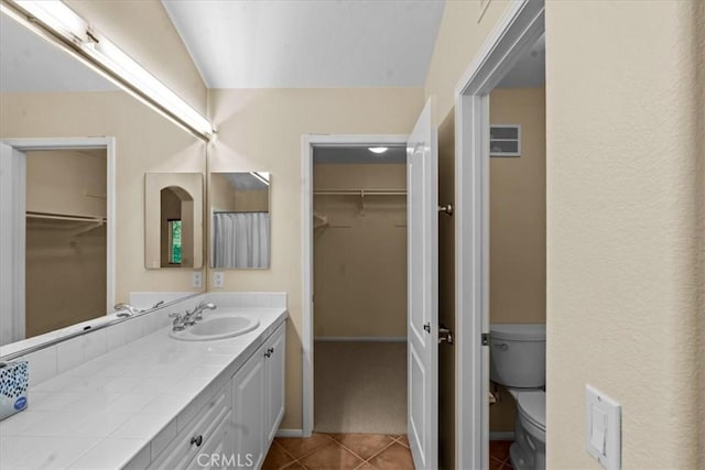 1 Firenze Ct, Newport Coast, CA 92657 - full bathroom featuring toilet, vanity, tile patterned flooring, a walk in closet, and vaulted ceiling