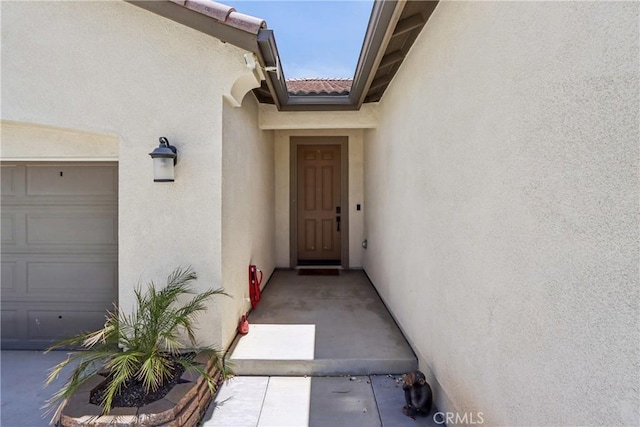 29167 Moraga St, Menifee, CA 92584 - entrance to property with stucco siding and a garage