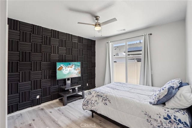 29167 Moraga St, Menifee, CA 92584 - bedroom with wood finished floors, ceiling fan, and an accent wall