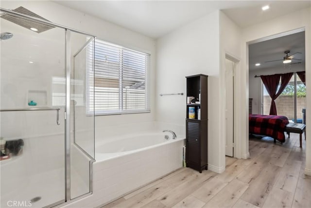 29167 Moraga St, Menifee, CA 92584 - bathroom with ensuite bath, a garden tub, wood finished floors, a stall shower, and ceiling fan