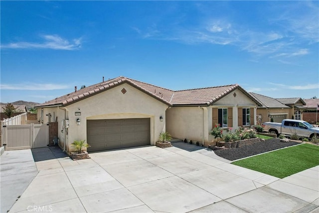 29167 Moraga St, Menifee, CA 92584 - view of front of house featuring an attached garage, stucco siding, driveway, a tiled roof, and a gate