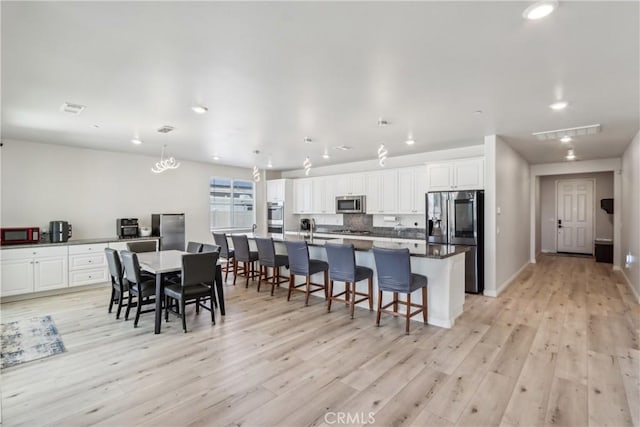 29167 Moraga St, Menifee, CA 92584 - dining room featuring light wood-style flooring, recessed lighting, and baseboards