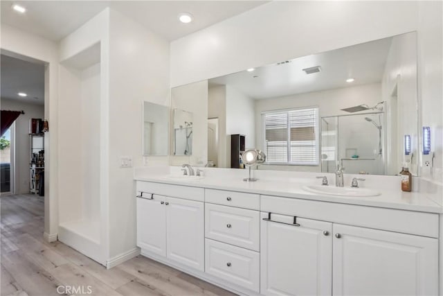 29167 Moraga St, Menifee, CA 92584 - full bathroom with a stall shower, double vanity, wood finished floors, and recessed lighting
