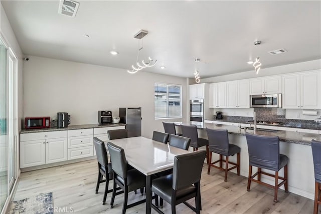 29167 Moraga St, Menifee, CA 92584 - dining room featuring light wood-style flooring and recessed lighting