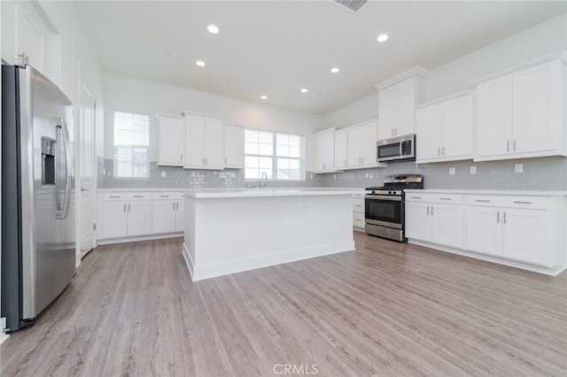 15926 Ellington Way, Chino Hills, CA 91709 - kitchen featuring appliances with stainless steel finishes, light wood finished floors, light countertops, decorative backsplash, and recessed lighting