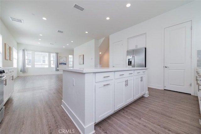 15926 Ellington Way, Chino Hills, CA 91709 - kitchen featuring stainless steel fridge, light wood-style floors, white cabinets, a center island, and light countertops