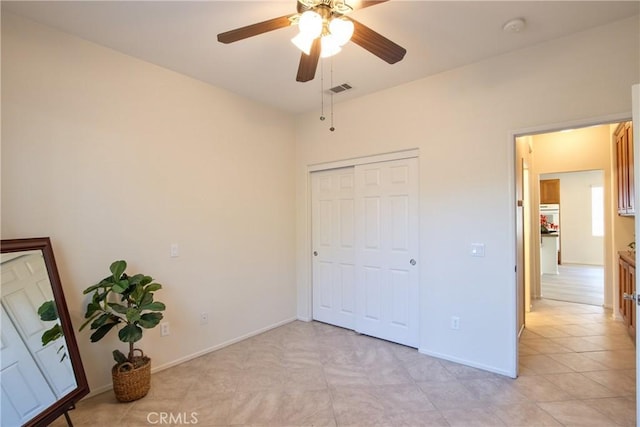 28046 Crystal Spring Dr, Menifee, CA 92584 - unfurnished bedroom featuring baseboards, a closet, and a ceiling fan