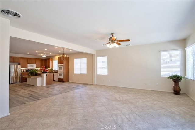 28046 Crystal Spring Dr, Menifee, CA 92584 - unfurnished living room with a ceiling fan, a chandelier, recessed lighting, and baseboards