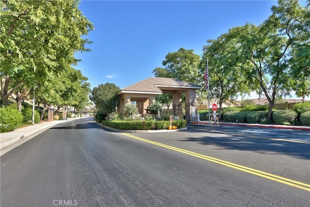 28046 Crystal Spring Dr, Menifee, CA 92584 - view of asphalt street with traffic signs and curbs