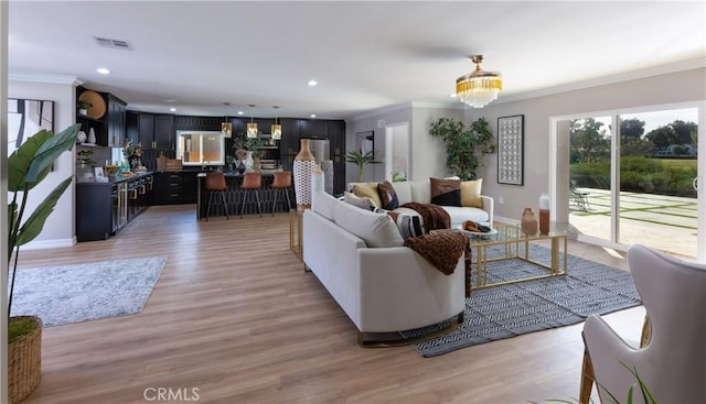 4325 N Country Club Ln, Long Beach, CA 90807 - living room with ornamental molding, recessed lighting, baseboards, light wood finished floors, and a chandelier