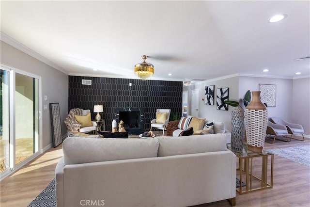 4325 N Country Club Ln, Long Beach, CA 90807 - living room with crown molding, an accent wall, wood finished floors, recessed lighting, and baseboards