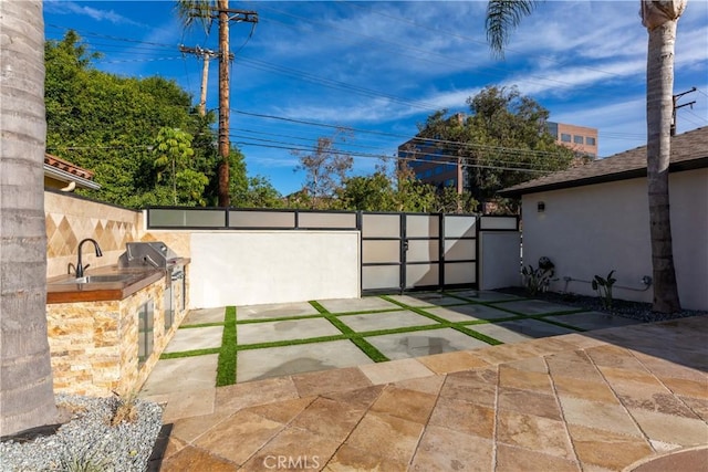 4325 N Country Club Ln, Long Beach, CA 90807 - view of patio / terrace featuring a sink, an outdoor kitchen, grilling area, and fence
