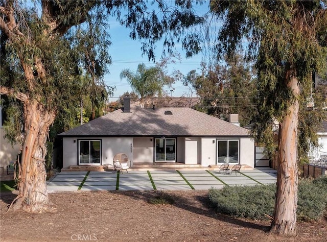 4325 N Country Club Ln, Long Beach, CA 90807 - back of house with a shingled roof, stucco siding, and a chimney