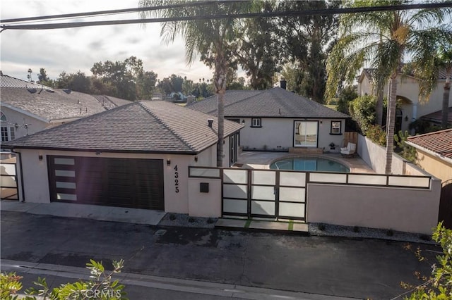4325 N Country Club Ln, Long Beach, CA 90807 - view of front of property with stucco siding, a garage, fence, and driveway