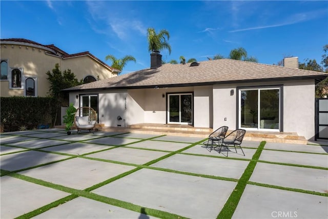 4325 N Country Club Ln, Long Beach, CA 90807 - rear view of house with a chimney, stucco siding, and a patio