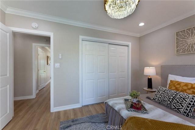 4325 N Country Club Ln, Long Beach, CA 90807 - bedroom featuring wood finished floors, baseboards, crown molding, a closet, and a chandelier